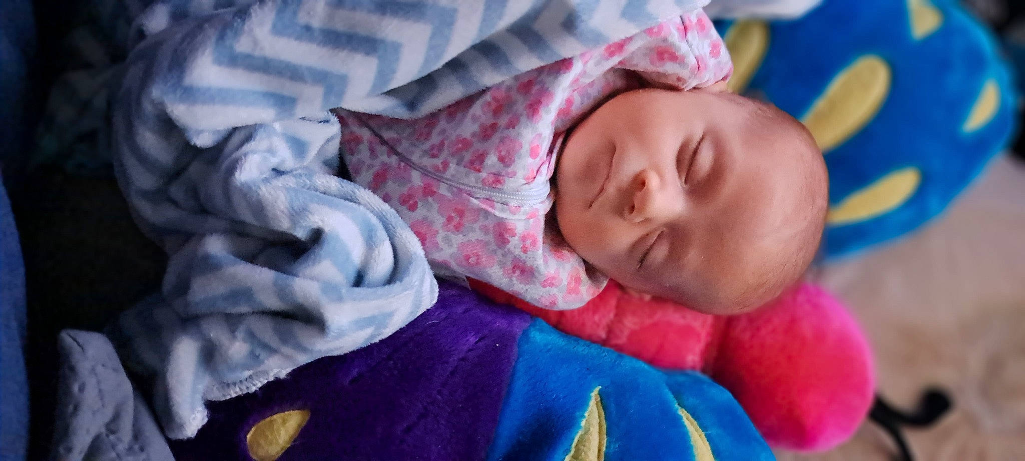 Brooklynn is registered to the contest to win money with this photo: baby, baby_products, baby_toddler_clothing, cheek, child, comfort, electric_blue, happy, linens, magenta, mouth, nose, pattern, person, pink, purple, room, skin, sleeve, textile