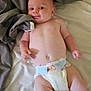 Cassius is registered to the contest to win money with this photo: baby, infant, diaper, bed, blanket, smile, skin, person, cute, lying_down, indoors, head, face, arm, leg, newborn, comfort, soft, rest, child