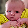 baby, infant, face, hands, yellow_clothing, portrait, closeup, newborn, cute, skin, expression, young_child, person, soft_background, indoors, small_hands, child, curious_eyes, bright_color, serious_expression