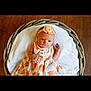 baby, infant, flower_headband, dress, basket, blanket, wooden_floor, portrait, cute, child, newborn, orange_pattern, headband, soft_texture, indoor, lying_down, adorable, young_child, peaceful, cozy
