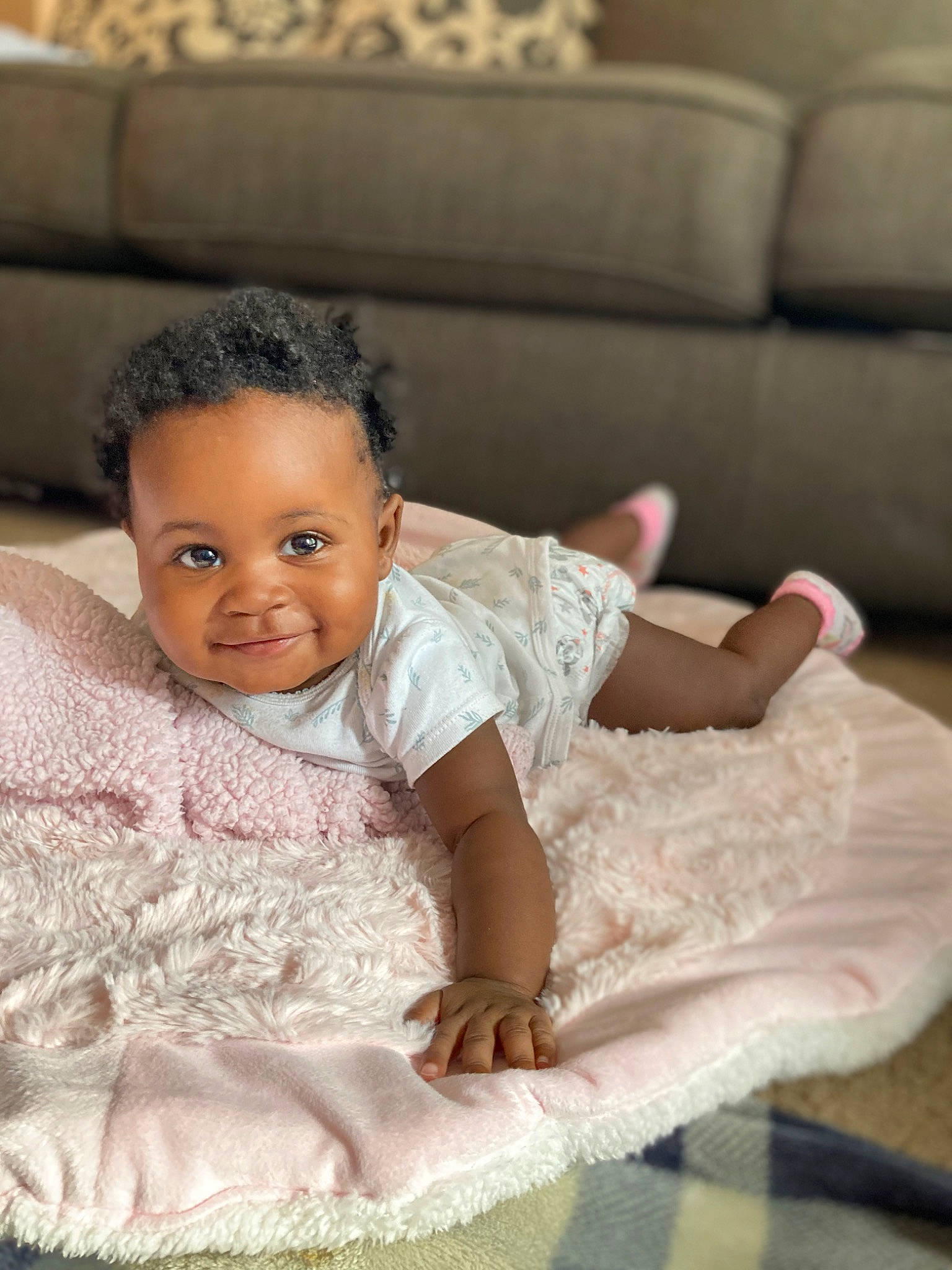 Arionna is registered to the contest to win money with this photo: arm, baby_toddler_clothing, comfort, couch, dress, embellishment, eye, flash_photography, flooring, happy, head, human_body, iris, joy, neck, person, pink, shoulder, skin, smile