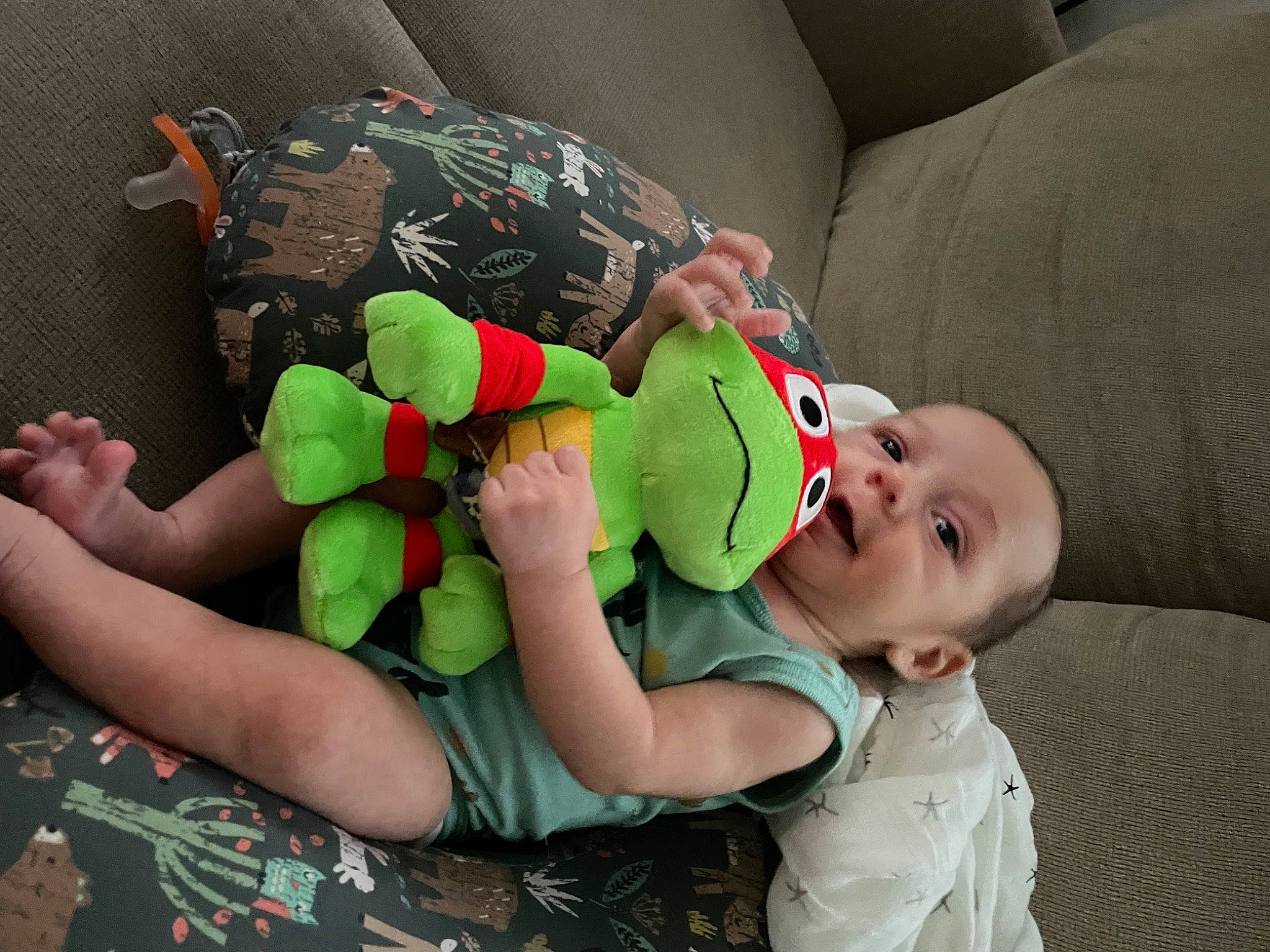 Raphael is registered to the contest to win money with this photo: arm, baby, baby_products, baby_toddler_clothing, child, comfort, couch, fictional_character, fun, hand, happy, knee, lap, nail, person, room, sock, t_shirt, thigh, toddler