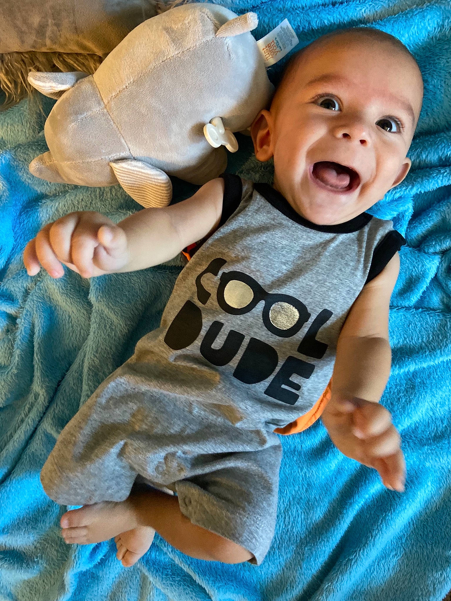 Clark joined the competition — help win amazing prizes! arm, baby, baby_products, baby_toddler_clothing, blue, child, comfort, eye, facial_expression, gesture, grass, happy, linens, pattern, person, skin, sleeve, smile, t_shirt, textile