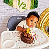 Davier joined the competition — help win amazing prizes! baby, child, birthday, half_birthday, high_chair, cake, chocolate, sprinkles, cake_topper, golden_decorations, balloon, tassel_garland, brick_wall, indoors, portrait, sitting, curly_hair, wide_eyes, festive, dessert