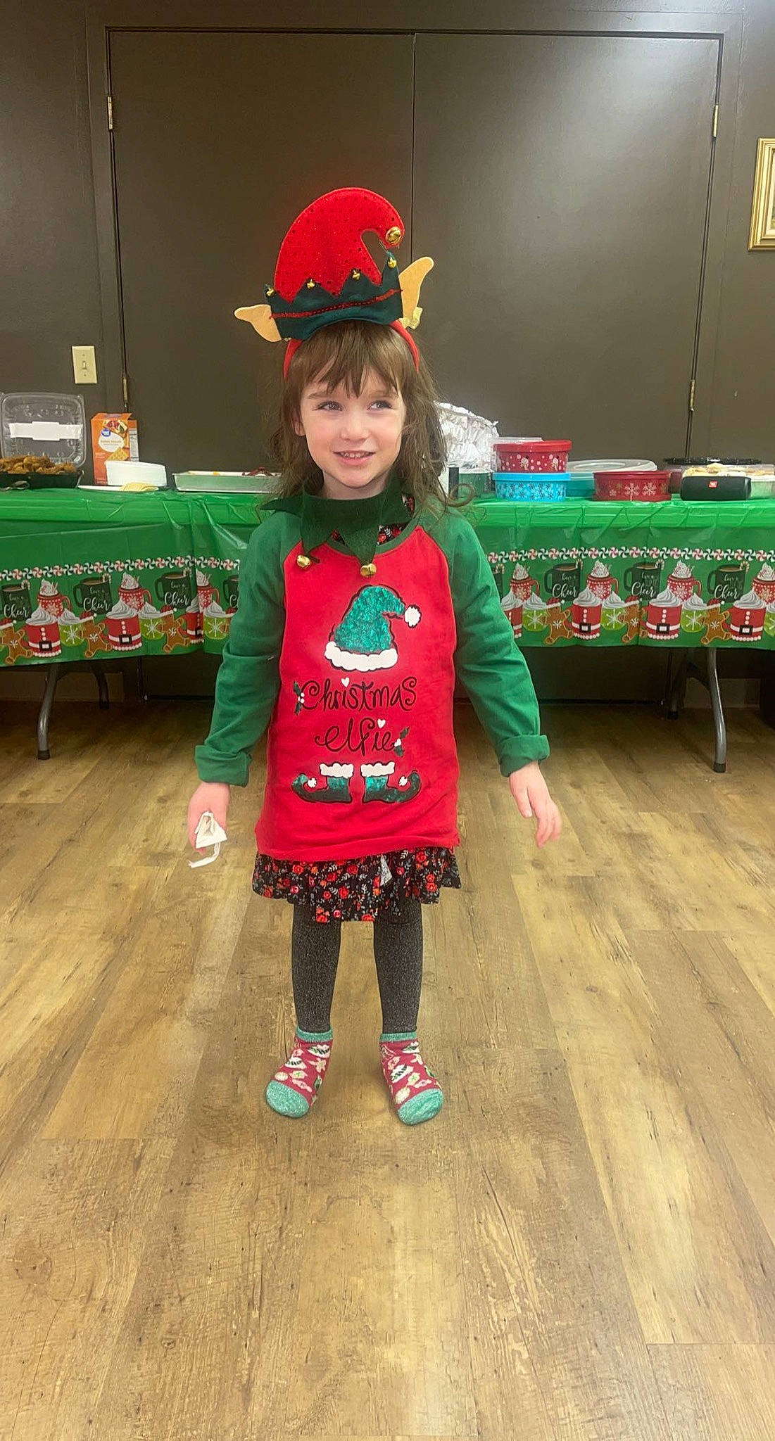 Ariel is registered to the contest to win money with this photo: baby_toddler_clothing, baseball_cap, cap, child, christmas, event, fashion_design, flooring, fun, happy, hat, holiday, joy, magenta, pattern, person, sleeve, sock, table, textile