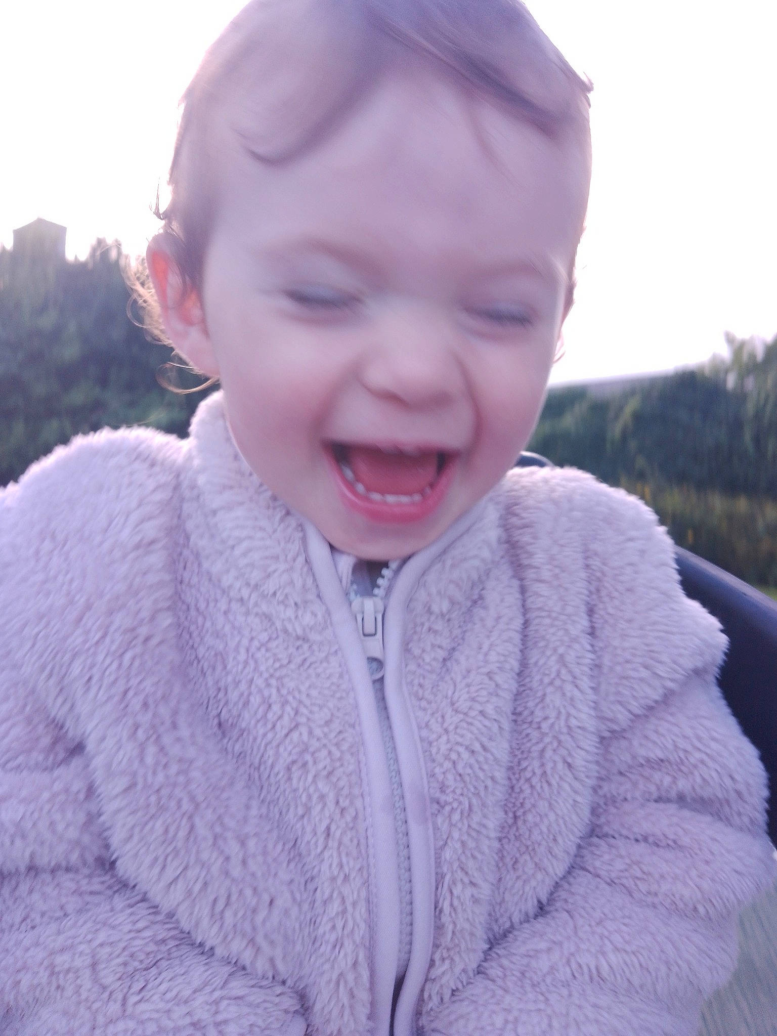 Joy participe au concours pour gagner de l'argent avec cette photo : baby, baby_toddler_clothing, child, fun, grass, happy, human_body, laugh, lip, magenta, neck, nose, person, pink, skin, sky, sleeve, smile, toddler, winter