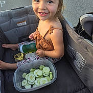 Melody is registered to the contest to win money with this photo: bottle, child, clothing, container, cucumber, cute, face, food, footwear, hair, happy, outdoor, person, playful, seat, skin, smile, stroller, summer, toddler