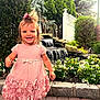 Melody joined the competition — help win amazing prizes! bow, child, cute, daylight, flowers, garden, girl, greenery, happy, nature, outdoor, pavement, pink_dress, plants, playful, portrait, smiling, toddler, walking, waterfall