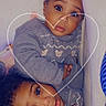 Neriah-Meriah is registered to the contest to win money with this photo: child, toddler, baby, sweater, cute, love, heart, indoor, portrait, face, curly_hair, matching_clothes, cozy, snuggle, two_children, expression, looking_up, skin, eyebrows, hands
