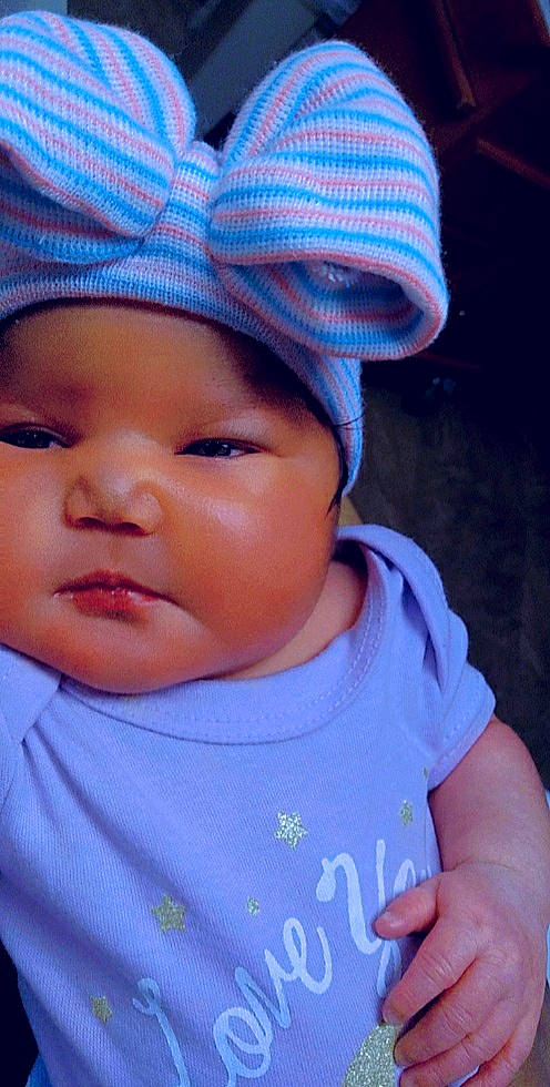 Kaycee is registered to the contest to win money with this photo: baby, baby_toddler_clothing, cap, cheek, chin, eyebrow, eyelash, happy, hat, headgear, headwear, iris, lip, mouth, nose, person, pink, purple, skin, sleeve