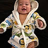 Roman joined the competition — help win amazing prizes! baby, infant, child, smiling, portrait, hooded_robe, bathrobe, animal_print, colorful_clothing, black_background, lying_down, face, eyes, open_mouth, hands, legs, indoor, closeup, happy, photography