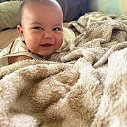 Roman joined the competition — help win amazing prizes! baby, infant, child, smiling, happy, face, portrait, blanket, bed, bedroom, cozy, soft, indoor, sitting, lying_down, clothing, warm_lighting, close_up, home, cute