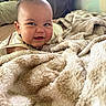 baby, infant, child, smiling, happy, face, portrait, blanket, bed, bedroom, cozy, soft, indoor, sitting, lying_down, clothing, warm_lighting, close_up, home, cute