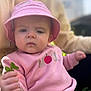 toddler, child, pink_hat, pink_sweater, plant, outdoor, portrait, baby, hand, face, expression, nature, casual_clothing, person, young_child, sitting, daylight, closeup, cute, hat