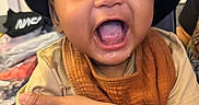 Taige is registered to the contest to win money with this photo: baby, child, smiling, happy, cap, hat, bib, mouth_open, indoor, person, arm, clothing, face, skin, expression, joy, holding, closeup, infant, young