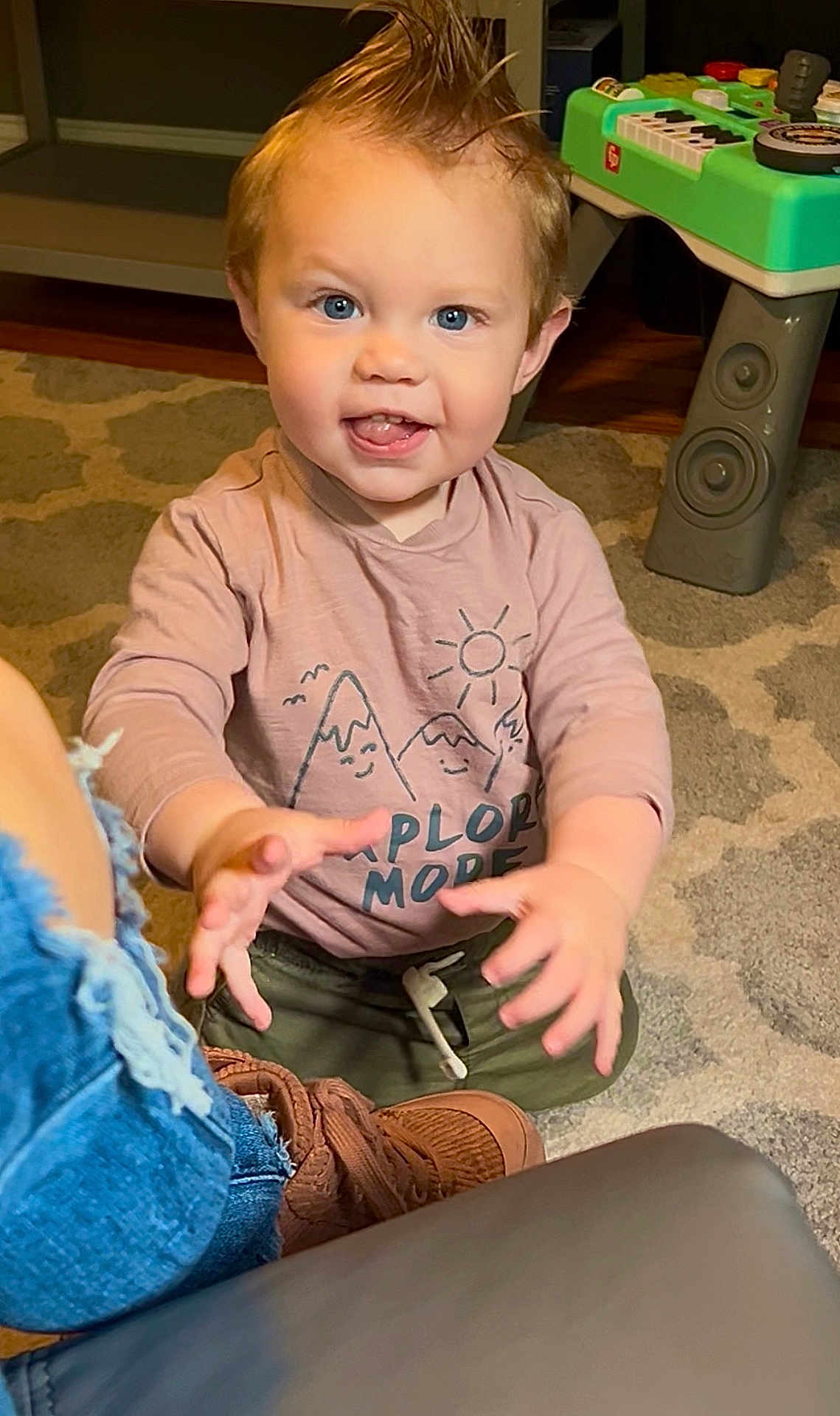 Knox joined the competition — help win amazing prizes! toddler, child, indoor, carpet, toy, shirt, pink_clothing, blue_eyes, happy, smiling, playing, hands, footwear, jeans, brown_shoes, furniture, wood_floor, hair, expression, person