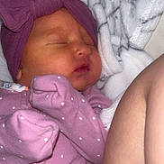 Carmen is registered to the contest to win money with this photo: newborn, baby, sleeping, purple_outfit, headband, bow, blanket, butterfly_patch, infant, cozy, soft, cute, child, face, peaceful, resting, indoors, closeup, skin, person