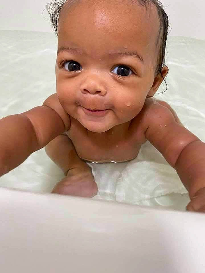 Amoura is registered to the contest to win money with this photo: arm, baby, baby_bathing, bathing, cheek, ear, eye, eyebrow, eyelash, flash_photography, hand, happy, iris, lip, mouth, neck, nose, person, shoulder, skin