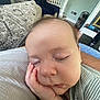 Miller is registered to the contest to win money with this photo: baby, sleeping, hand, face, closeup, couch, blanket, striped_clothing, indoor, cozy, peaceful, child, furniture, living_room, pillow, soft_texture, relaxation, infant, person, resting