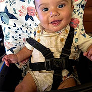 Mark joined the competition — help win amazing prizes! baby, child, infant, smiling, happy, portrait, high_chair, harness, floral, patterned, striped_clothing, bib, overalls, seated, indoors, close_up, brown_hair, baby_teeth, drooling, photography