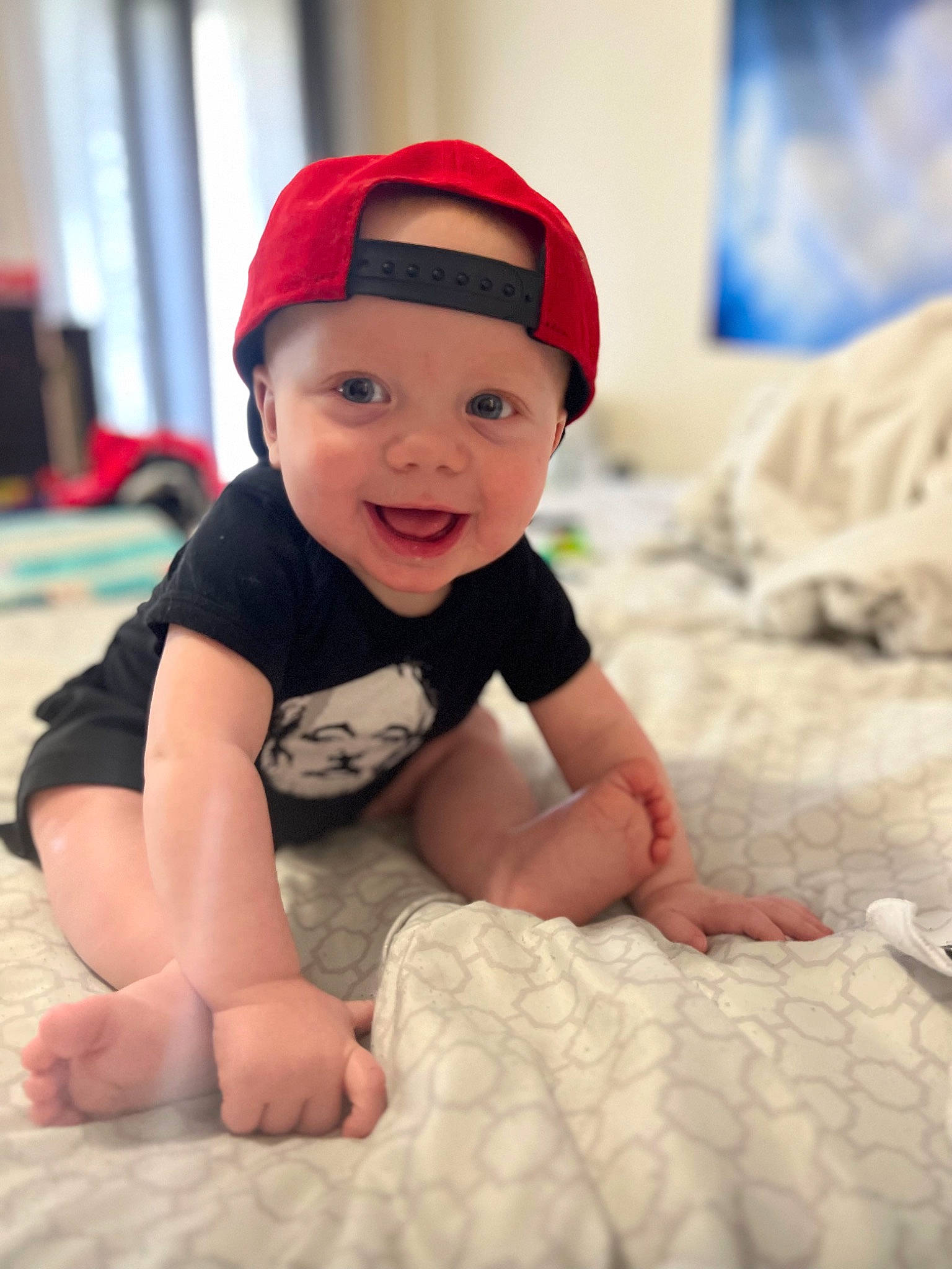 Oliver is registered to the contest to win money with this photo: baby, baby_toddler_clothing, cap, carmine, child, comfort, flash_photography, flooring, fun, happy, headwear, joy, linens, person, portrait_photography, room, sitting, skin, sleeve, smile
