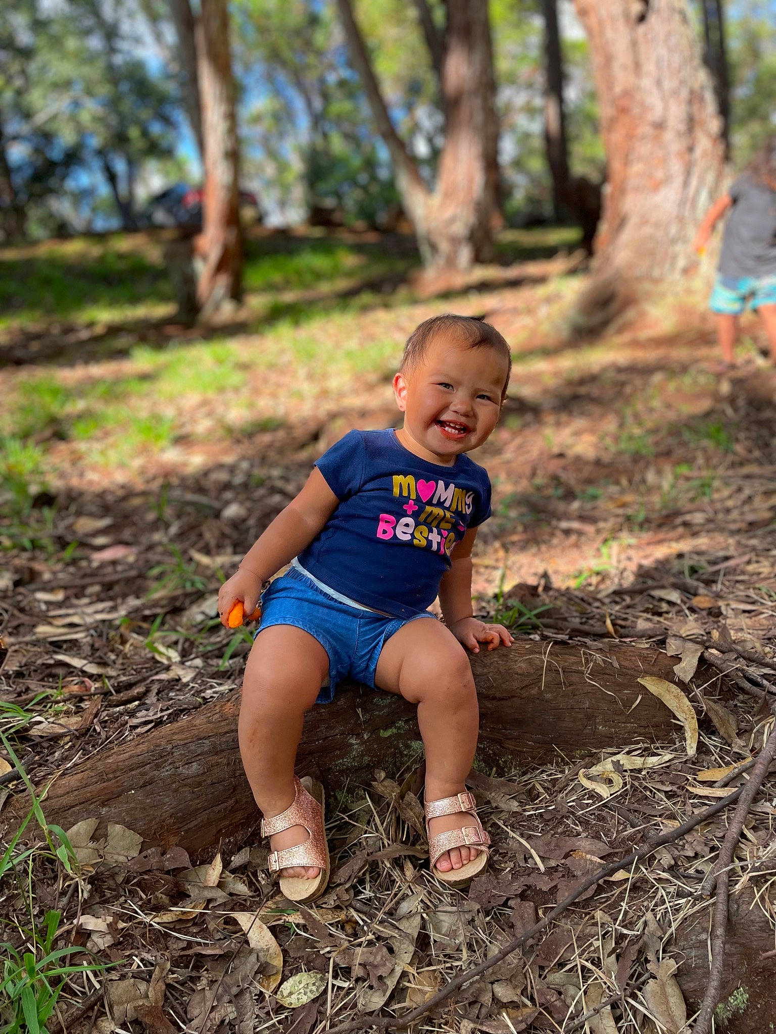 Azariah is registered to the contest to win money with this photo: automotive_tire, grass, hand, happy, joy, leaf, leg, leisure, natural_environment, people_in_nature, person, plant, shorts, smile, sunlight, thigh, tire, toddler, tree, wheel