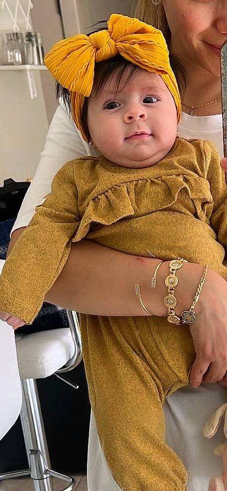 Giselle joined the competition — help win amazing prizes! baby, baby_toddler_clothing, blond, cap, cheek, child, eye, facial_expression, fashion_accessory, fun, happy, headwear, jewellery, pattern, person, sitting, skin, sleeve, t_shirt, toddler