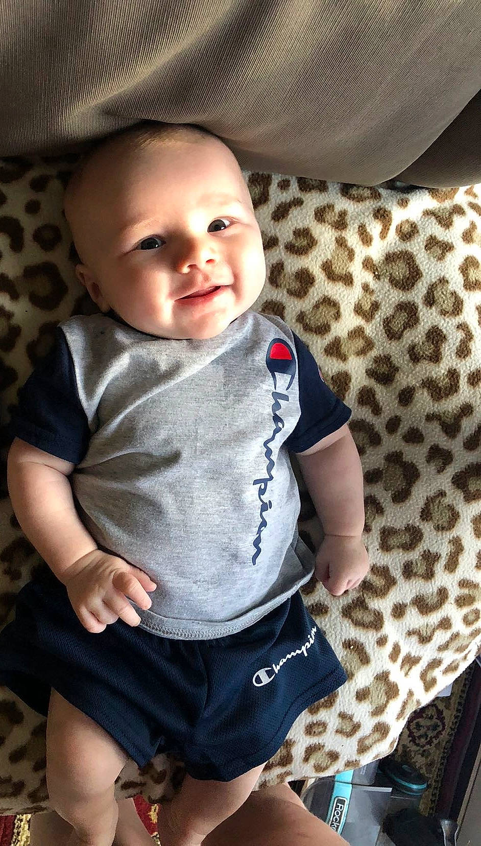 Carter is registered to the contest to win money with this photo: baby, baby_toddler_clothing, cheek, child, collar, comfort, elbow, electric_blue, happy, human_leg, iris, pattern, person, sitting, skin, sleeve, smile, t_shirt, textile, thigh