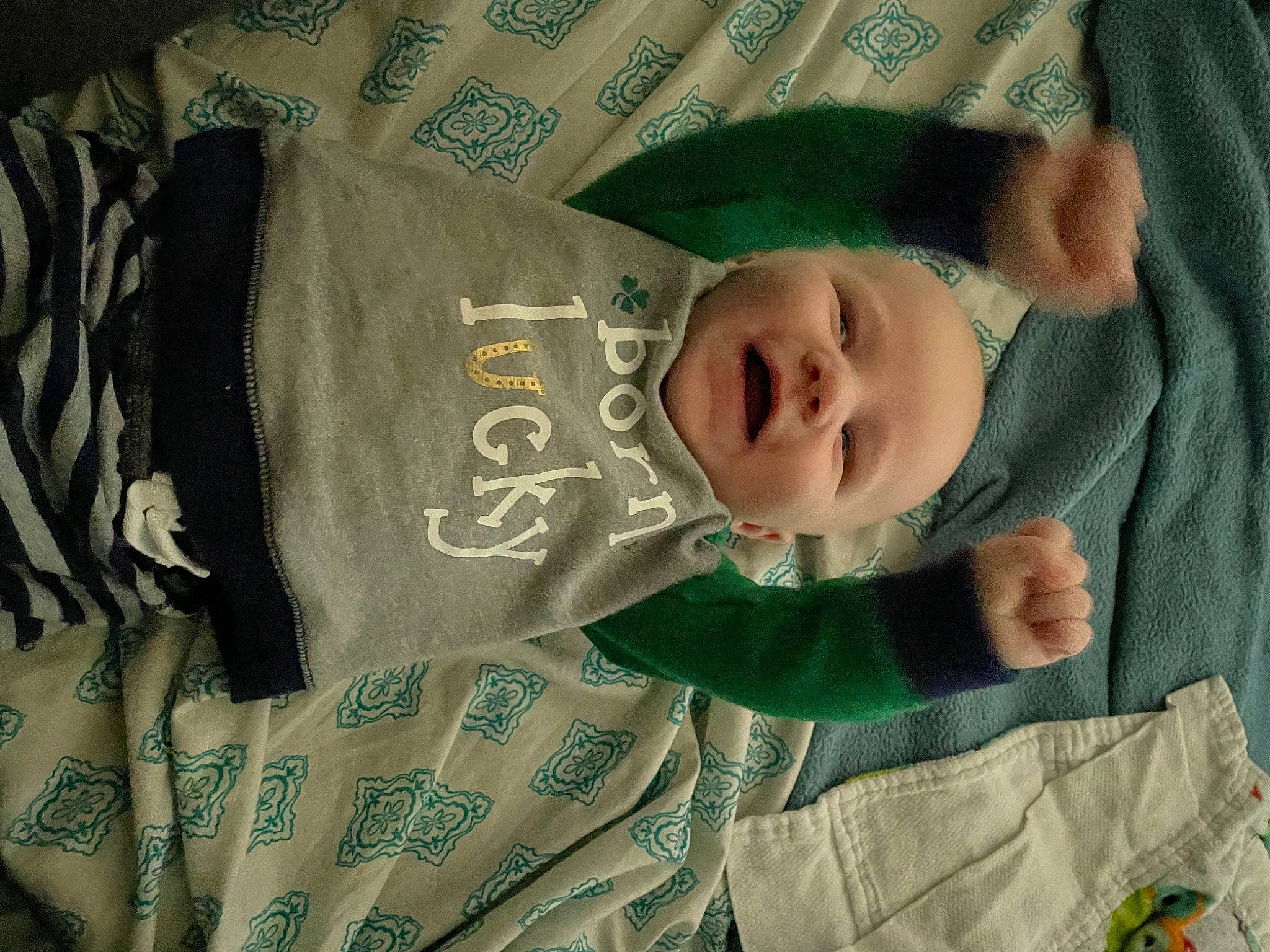 Carter is registered to the contest to win money with this photo: baby, baby_products, baby_toddler_clothing, child, comfort, face, facial_expression, head, linens, pattern, person, room, sleeve, smile, textile, toddler