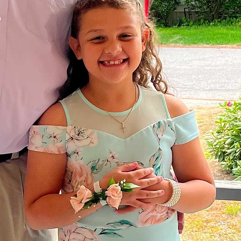 Christina is registered to the contest to win money with this photo: accessories, child, clothing, dress, face, female, flower, girl, grass, happy, head, jewelry, necklace, person, petal, photography, plant, portrait, sleeve, smile
