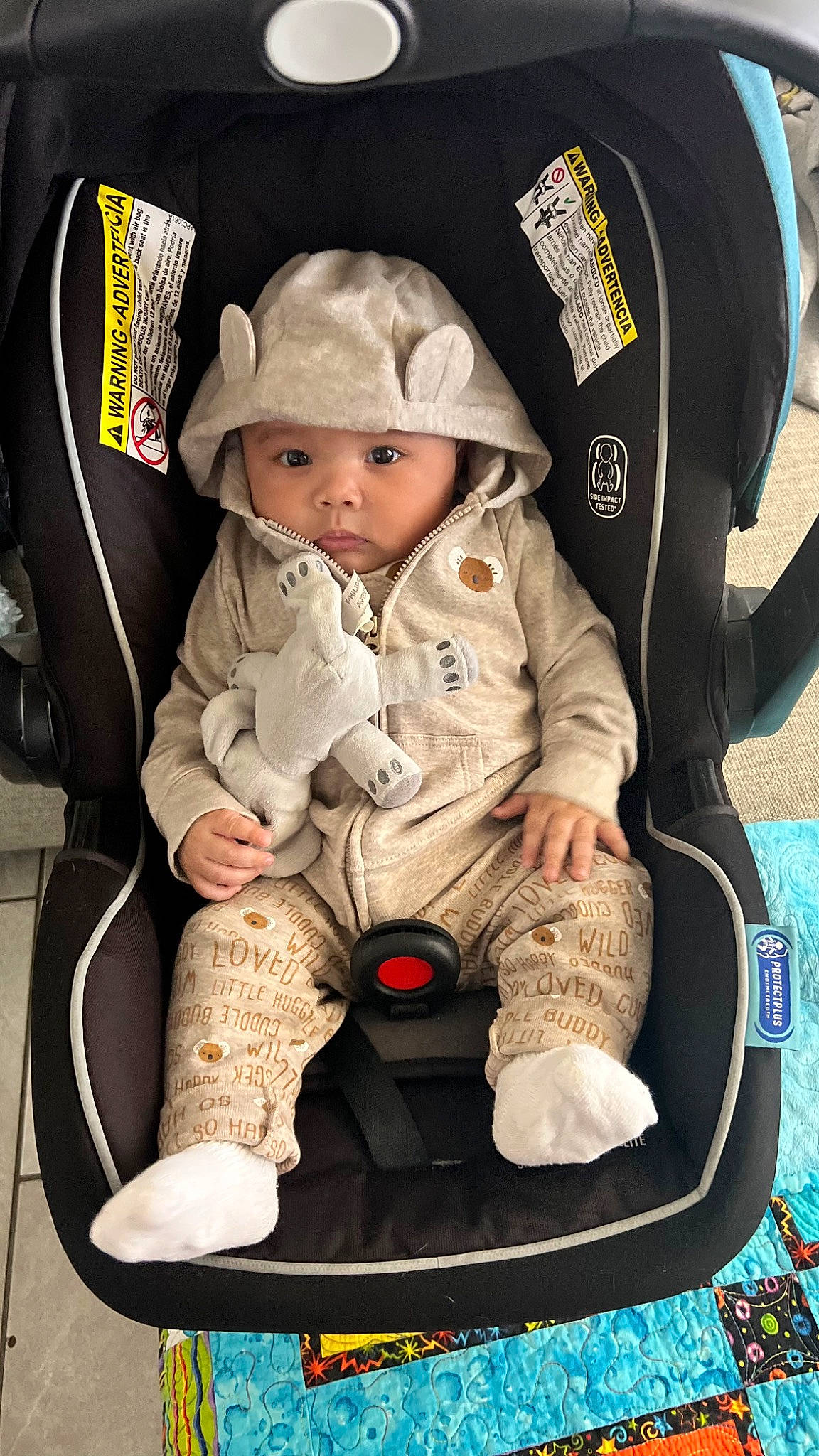 Braxton is registered to the contest to win money with this photo: baby, baby_carriage, baby_products, baby_safety, baby_toddler_clothing, baseball_cap, cap, car_seat, carmine, child, comfort, fashion_accessory, fun, gesture, hat, headwear, lap, person, sitting, sleeve