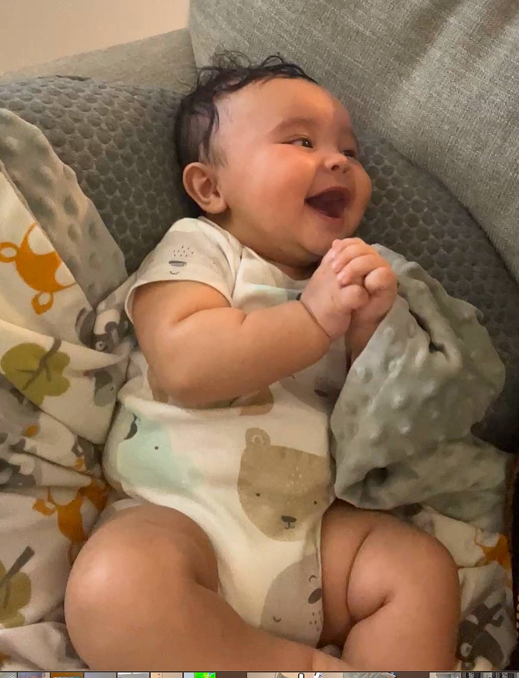 Braxton is registered to the contest to win money with this photo: baby, baby_toddler_clothing, cheek, child, comfort, finger, happy, human_leg, knee, linens, mouth, pattern, person, product, skin, smile, stomach, thigh, thumb, toddler