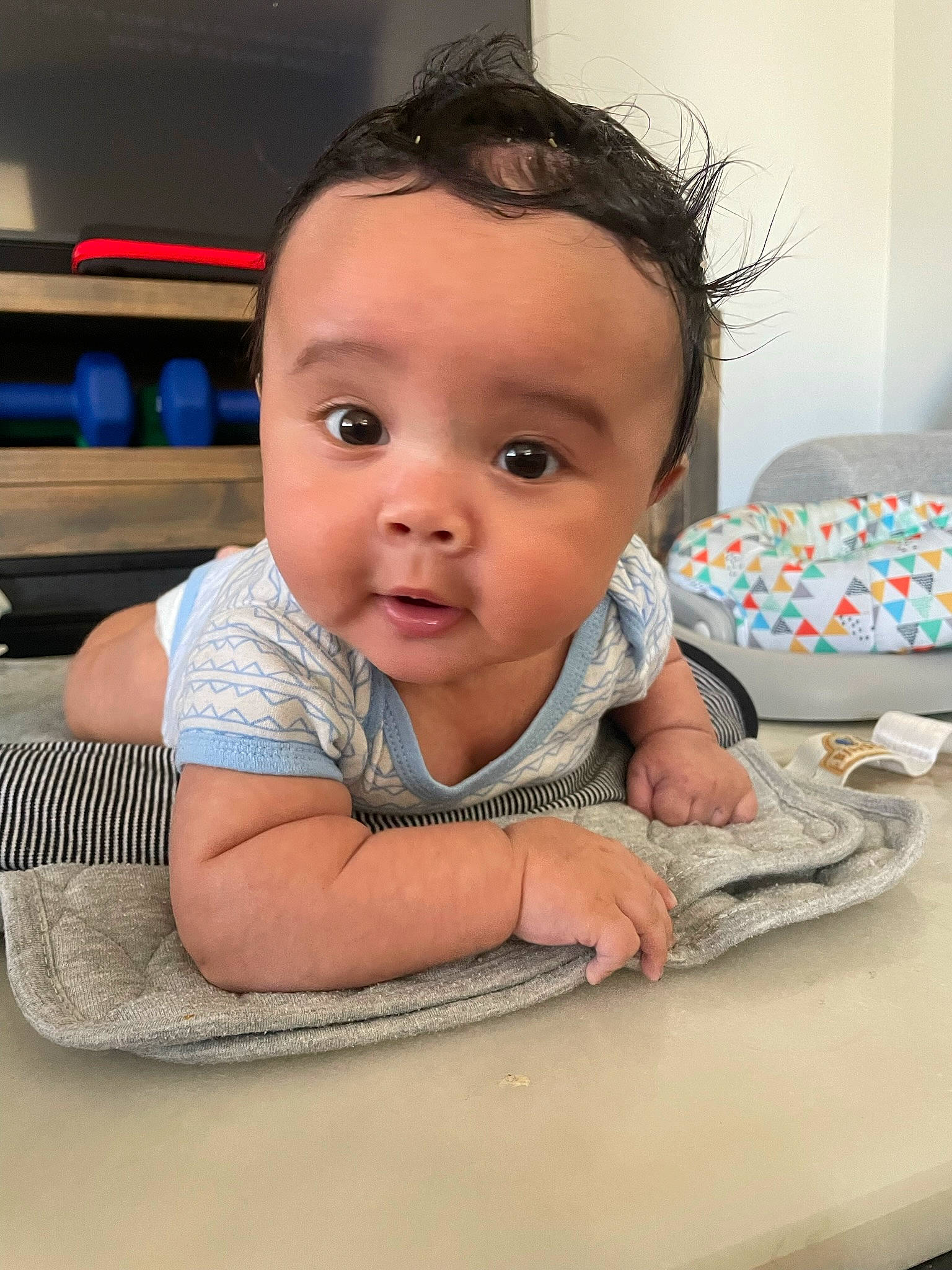 Braxton joined the competition — help win amazing prizes! baby, baby_toddler_clothing, cheek, child, comfort, eyelash, facial_expression, floor, flooring, fun, happy, iris, linens, nose, person, room, sitting, skin, smile, toddler