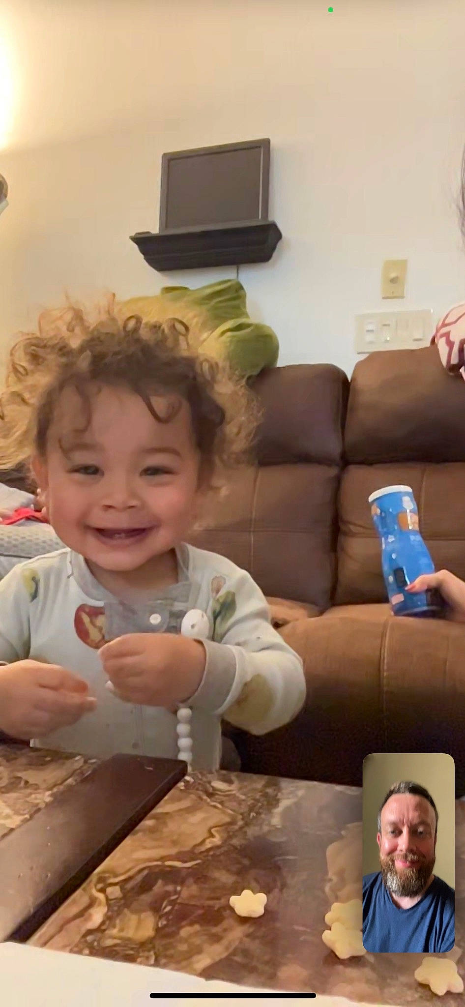 Kaiden is registered to the contest to win money with this photo: baby, cheek, child, comfort, couch, event, finger, fun, happy, joy, living_room, person, picture_frame, room, sitting, skin, smile, snapshot, table, throw_pillow