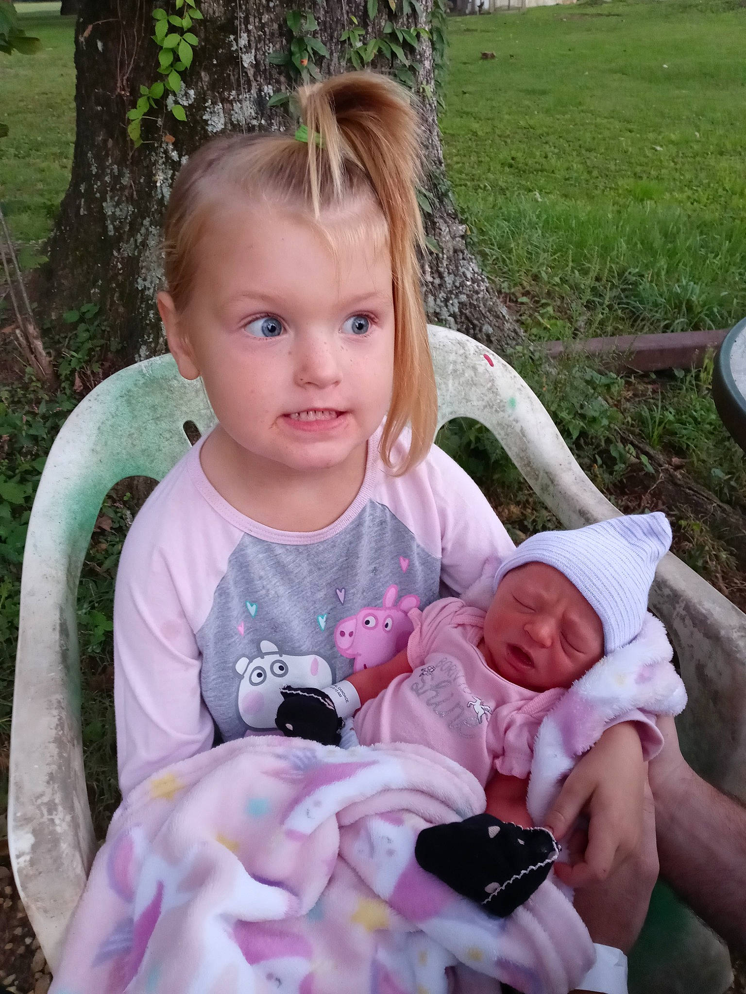 Rylie is registered to the contest to win money with this photo: baby, baby_products, baby_toddler_clothing, child, eye, finger, fun, grass, green, hand, happy, head, headwear, people_in_nature, person, photograph, pink, plant, skin, toddler