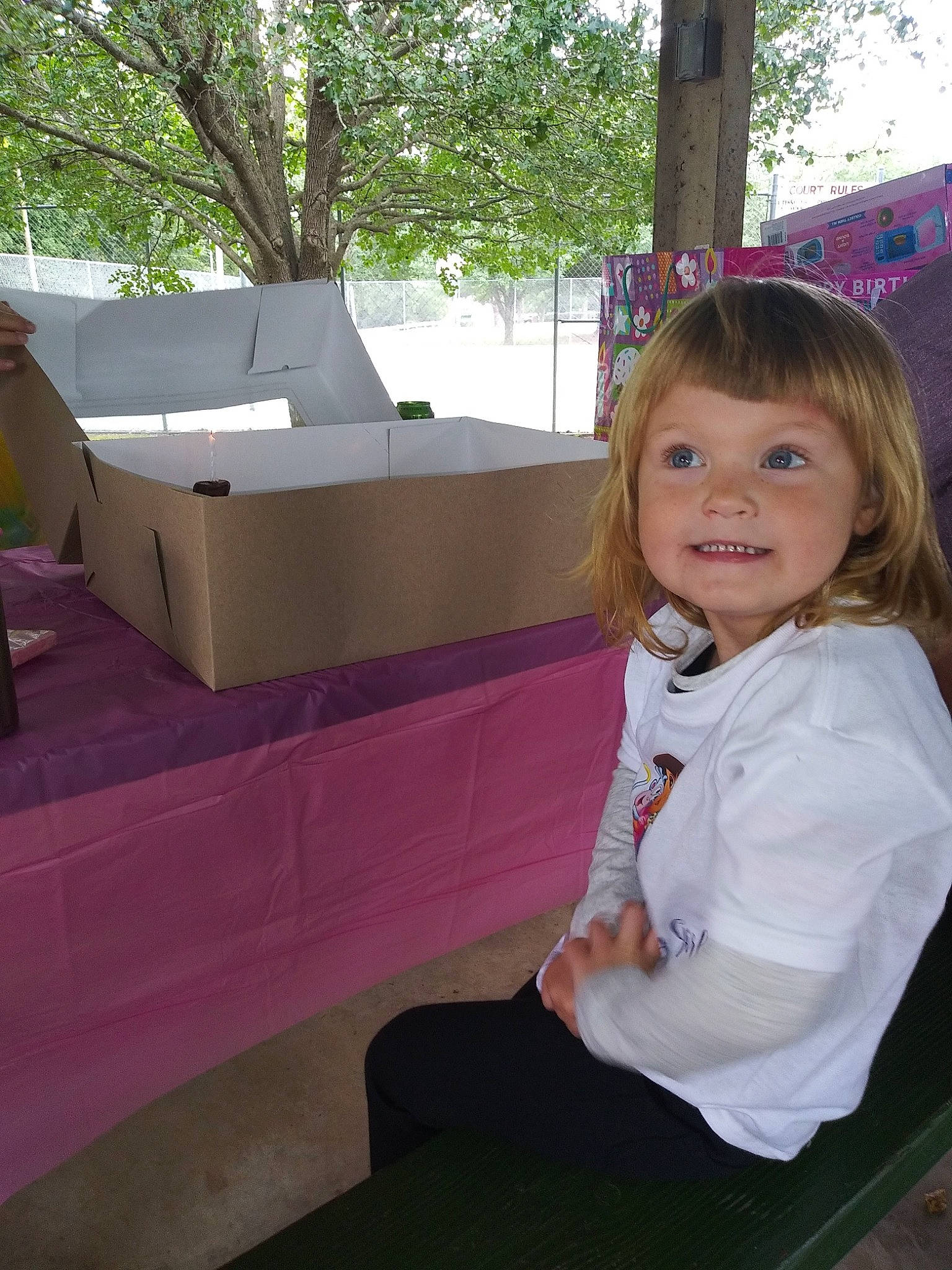 Rylie is registered to the contest to win money with this photo: child, eye, flooring, fun, grass, happy, joy, leisure, magenta, person, pink, play, recreation, room, sitting, smile, t_shirt, toddler, travel, tree