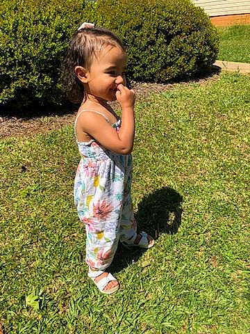 Kailani is registered to the contest to win money with this photo: baby, baby_toddler_clothing, child, flooring, fun, garden, grass, grass_family, grassland, groundcover, happy, hedge, landscape, lawn, people_in_nature, person, plant, shrub, soil, toddler