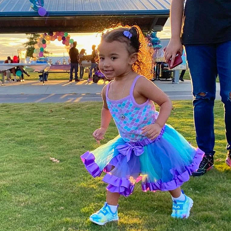 Kailani is registered to the contest to win money with this photo: baby_toddler_clothing, blue, child, clothing, electric_blue, event, facial_expression, fun, grass, happy, joy, lawn, leisure, magenta, person, pink, pole, purple, recreation, shoe