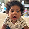 Malakai joined the competition — help win amazing prizes! baby, candid, casual_clothing, child, closeup, curiosity, curly_hair, cute, expression, face, indoor, infant, nike, person, portrait, sitting, soft_background, striped_shirt, toddler, young_child