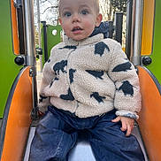 Rafaël participe au concours pour gagner de l'argent avec cette photo : blue_eyes, casual_clothing, child, curious_expression, daylight, face, fleece_jacket, hand, metal_slide, muddy, outdoor, pants, play_equipment, playground, portrait, shoes, sitting, slide, toddler, trees