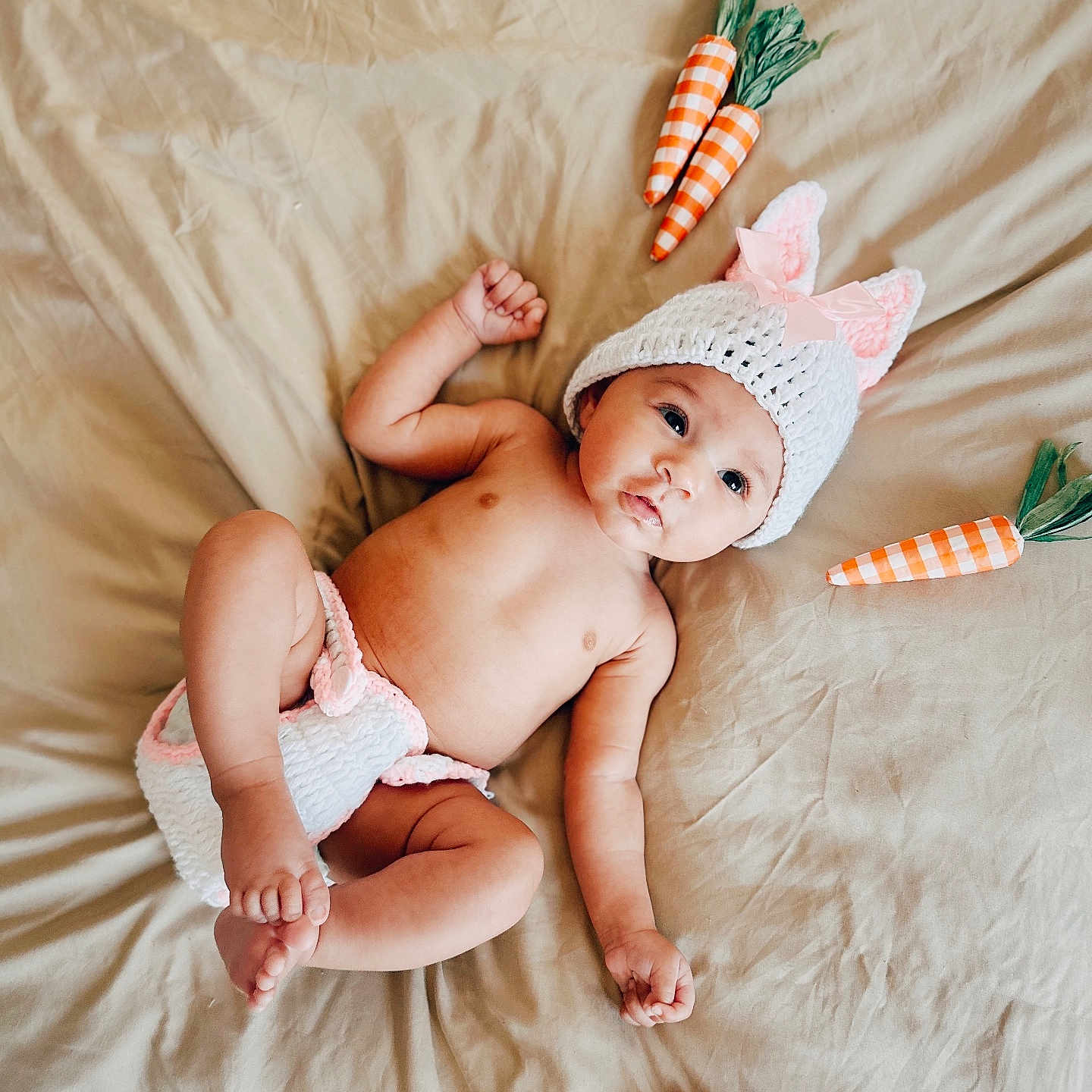 Pamela is registered to the contest to win money with this photo: baby, bodypart, bonnet, cap, carrot, clothing, diaper, face, finger, food, hand, hat, head, newborn, person, photography, plant, portrait, produce, vegetable
