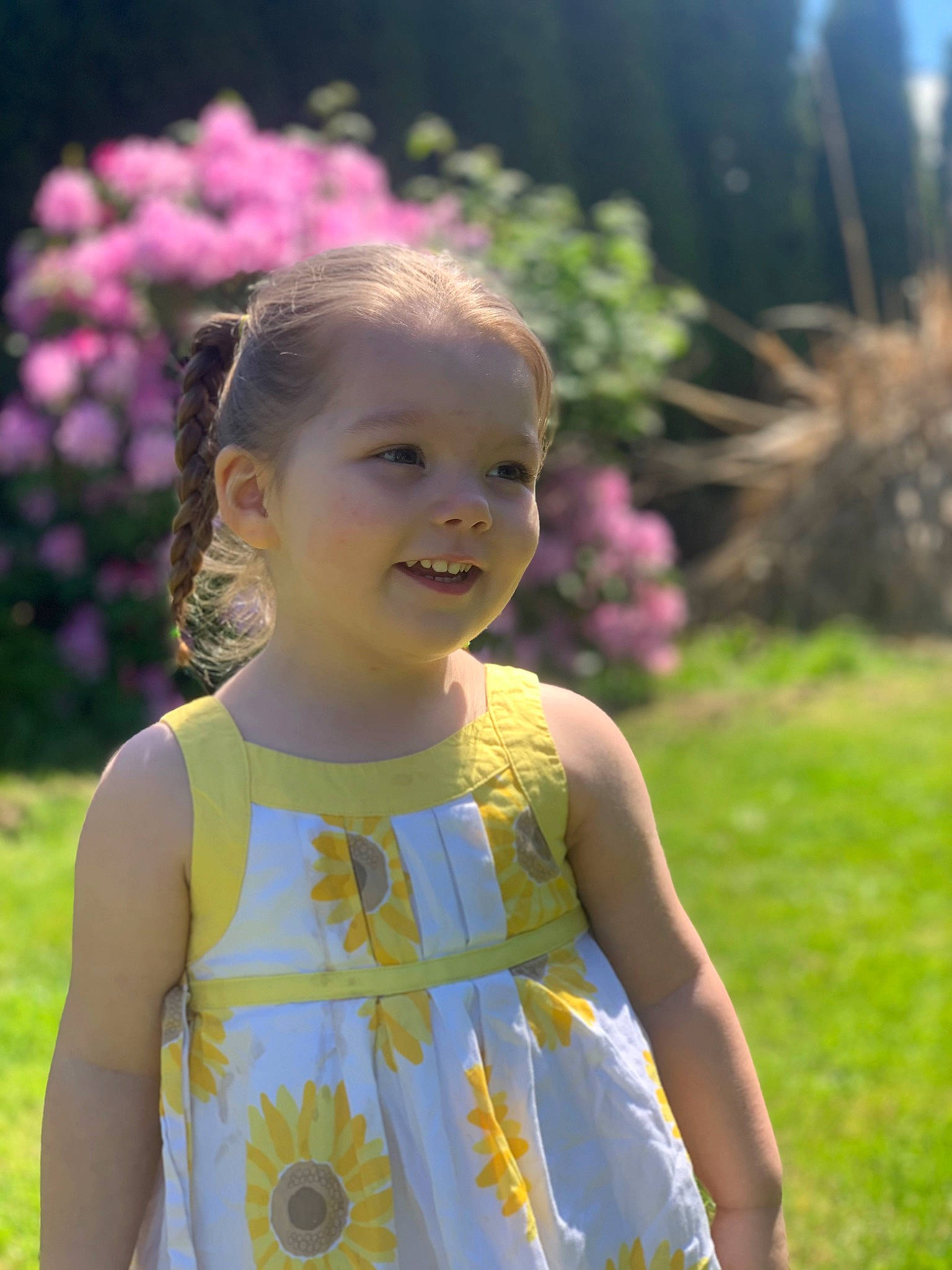 Calliope is registered to the contest to win money with this photo: baby_toddler_clothing, botany, child, eye, facial_expression, flower, fun, grass, happy, head, iris, leaf, nature, people_in_nature, person, pink, plant, skin, smile, sunlight