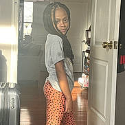 Mia is registered to the contest to win money with this photo: baggage, blackhair, blouse, child, clothing, couch, door, face, female, furniture, girl, hair, happy, head, pajamas, person, sitting, sleeve, smile, standing