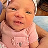 Amoura joined the competition — help win amazing prizes! baby, newborn, infant, pink_clothing, headband, cute, face, hand, tattoo, portrait, closeup, child, person, skin, human, expression, holding, soft, indoors, cozy