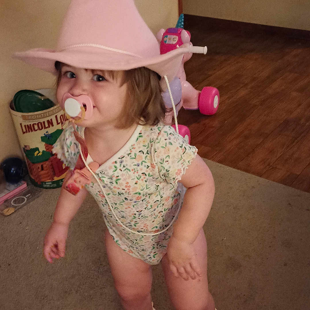 Skylynn is registered to the contest to win money with this photo: baby, bodypart, bonnet, can, clothing, cowboyhat, face, finger, footwear, hardwood, hat, head, person, photography, portrait, shoe, shorts, sunhat, tin, wood