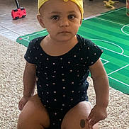 Noelle is registered to the contest to win money with this photo: accessories, architecture, baby, bathingcap, cap, clothing, costume, dress, face, hat, head, headband, outdoors, person, photography, portrait, shorts, sitting, swimwear, toy