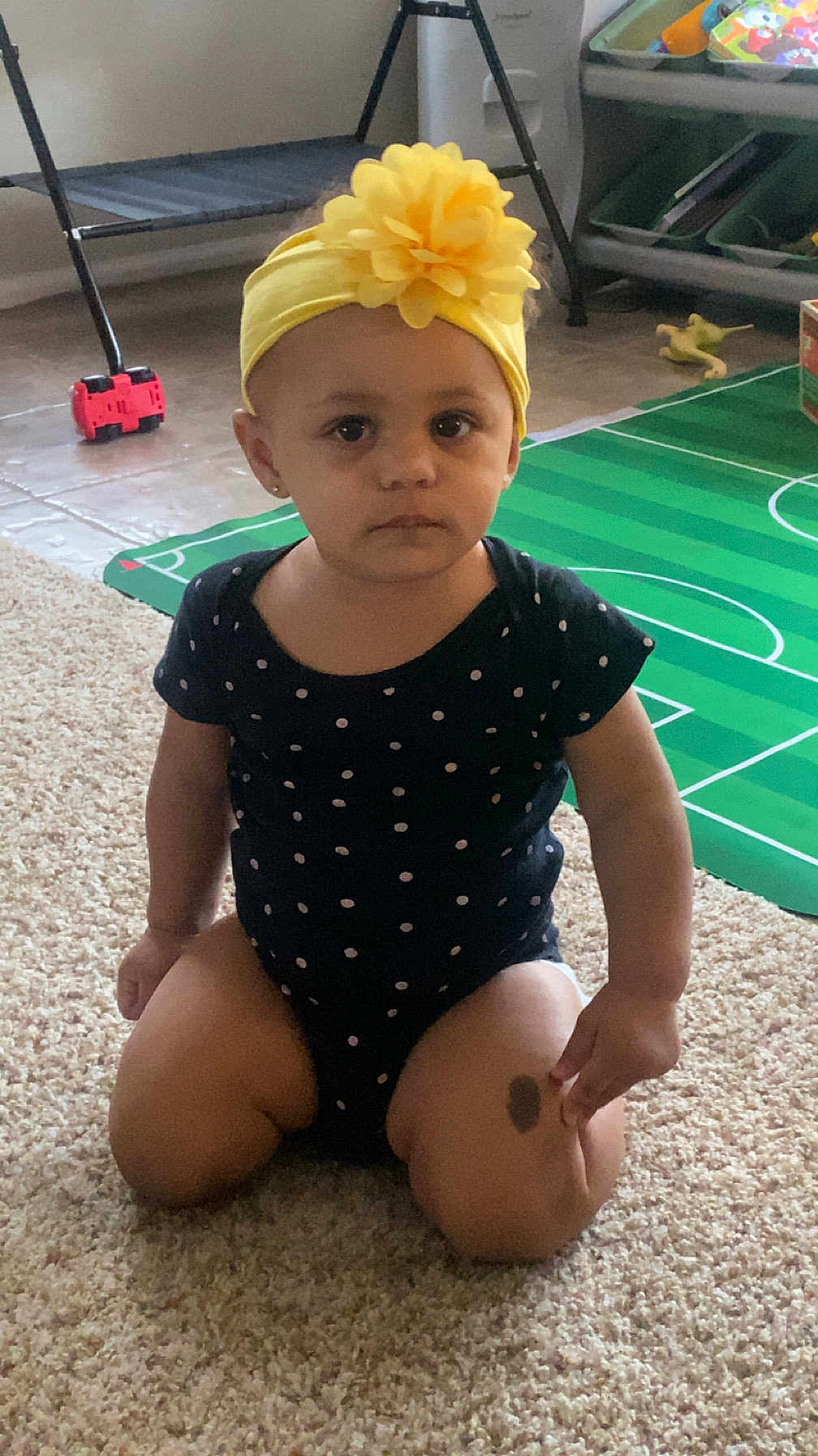 Noelle is registered to the contest to win money with this photo: accessories, architecture, baby, bathingcap, cap, clothing, costume, dress, face, hat, head, headband, outdoors, person, photography, portrait, shorts, sitting, swimwear, toy