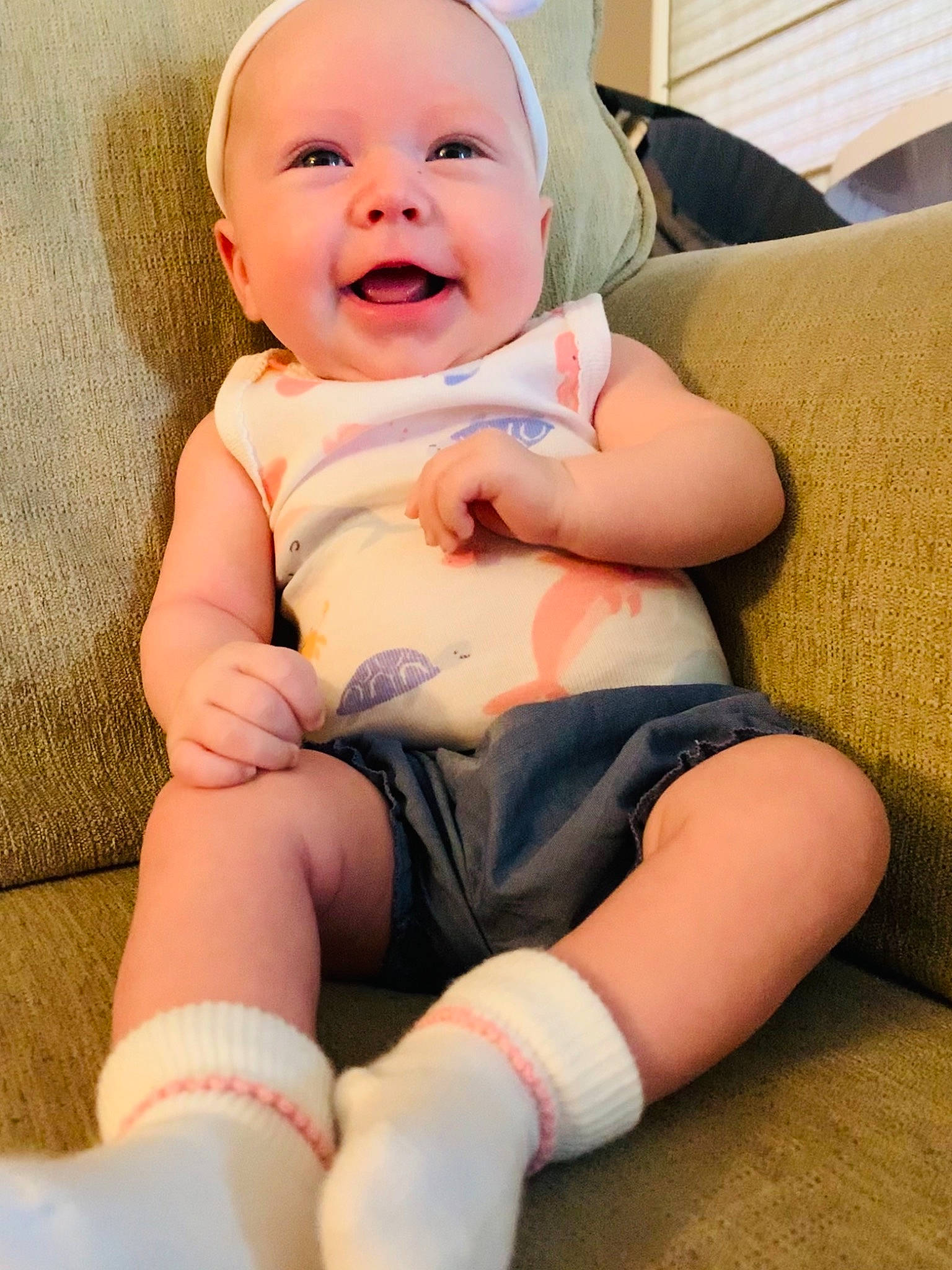 Brexleigh is registered to the contest to win money with this photo: baby, baby_toddler_clothing, cheek, child, comfort, couch, elbow, eye, finger, happy, hat, human_leg, knee, muscle, person, pink, skin, smile, stomach, thigh