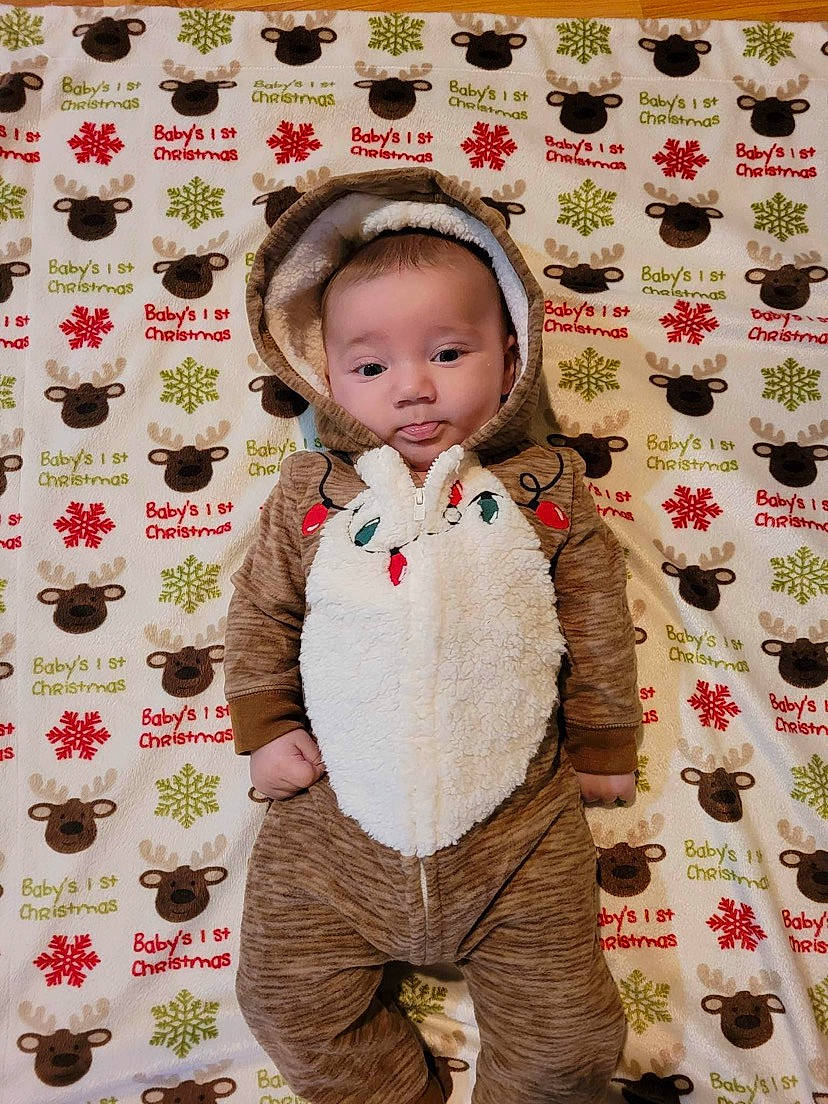 Rowan is registered to the contest to win money with this photo: baby, baby_toddler_clothing, cheek, child, design, facial_expression, fashion, flooring, happy, human, leaf, linens, outerwear, pattern, person, pink, red, sleeve, textile, toddler