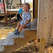 Weston joined the competition — help win amazing prizes! child, toddler, smile, outdoor, wooden_stairs, sippy_cup, shoes, sunlight, deck, grass, wood, person, playful, casual, daylight, happy, clothing, nature, summer, background